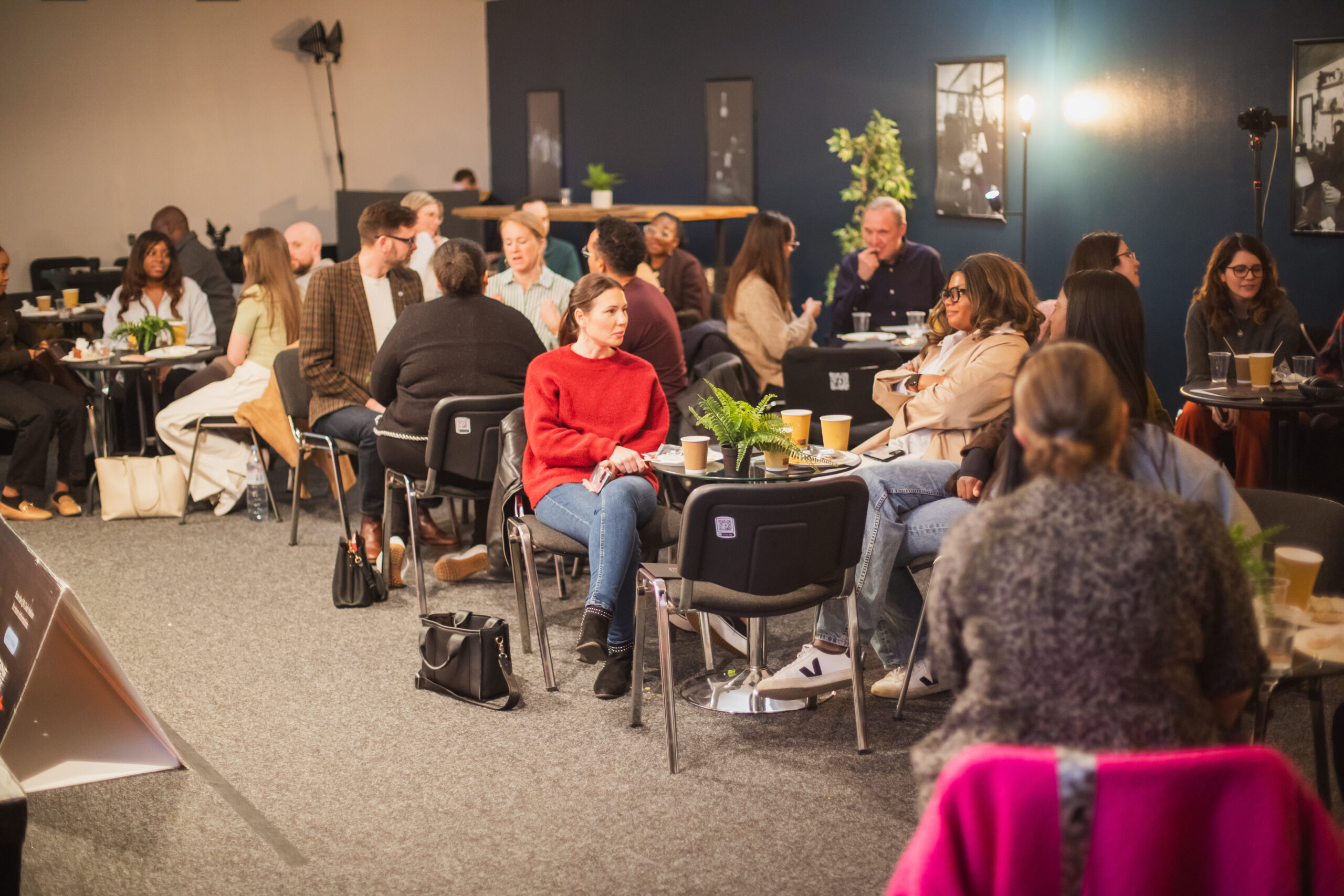 Audience seated in a room listening at an IGNITE! event